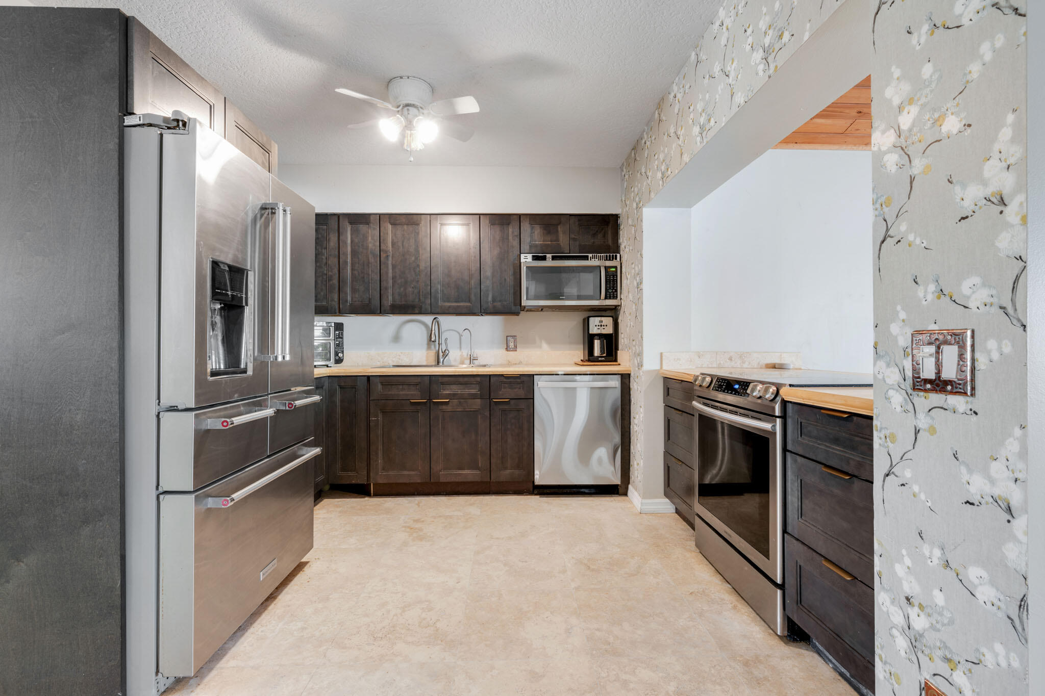 1216 Neoga Street Jupiter, FL 33458 - Photo 7 of 27 a kitchen with stainless steel appliances a stove a sink and a refrigerator