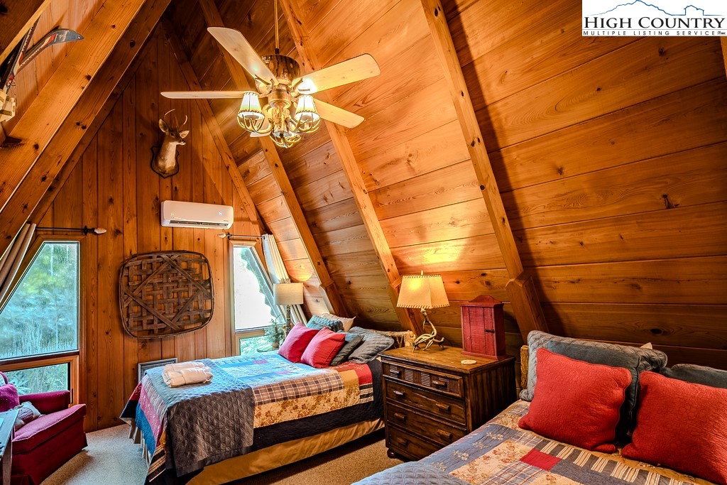 268 Cherry Drive Boone, NC 28607 - Photo 30 of 33 a bedroom with a bed and a chandelier