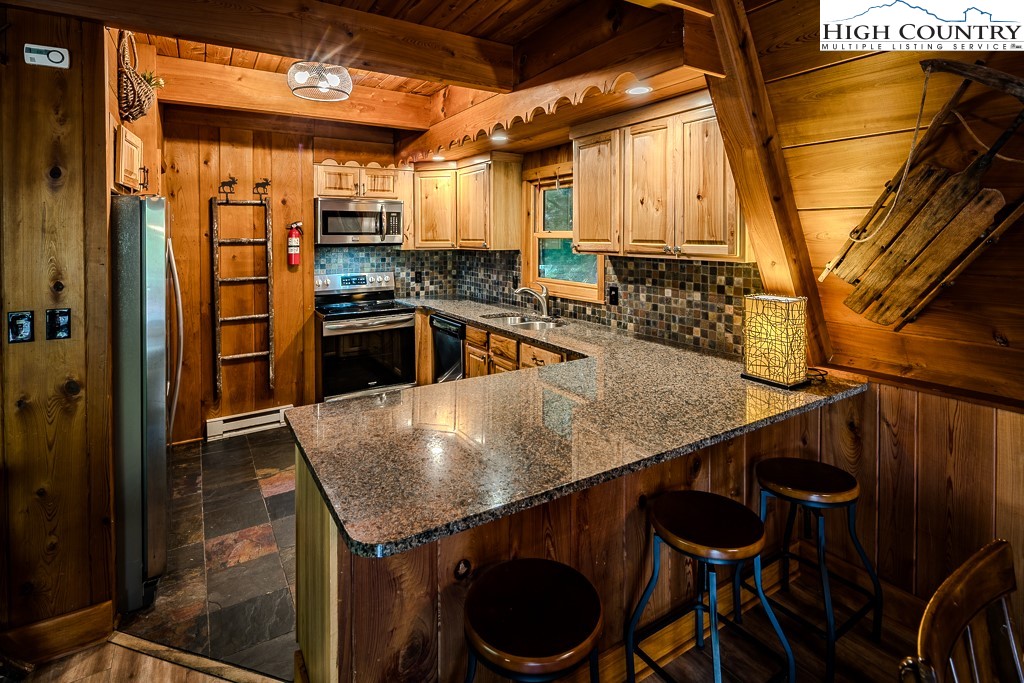 268 Cherry Drive Boone, NC 28607 - Photo 7 of 33 a kitchen with stainless steel appliances granite countertop a sink a stove and a refrigerator