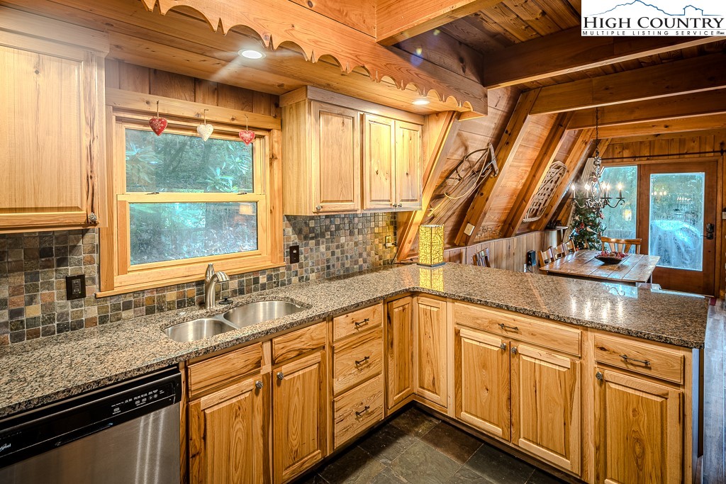 268 Cherry Drive Boone, NC 28607 - Photo 8 of 33 a kitchen with stainless steel appliances granite countertop a sink a stove and cabinets