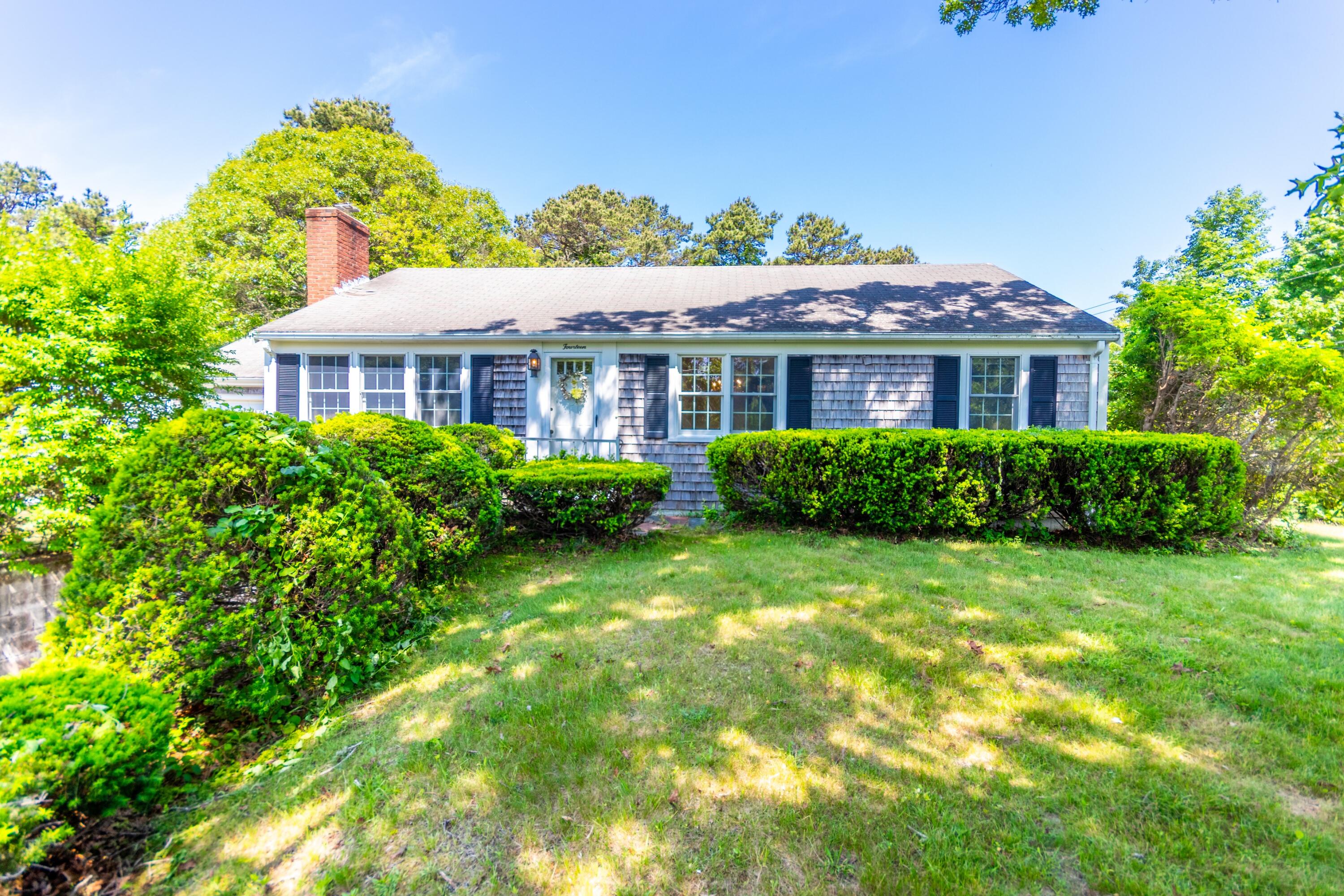 a front view of house with yard and green space