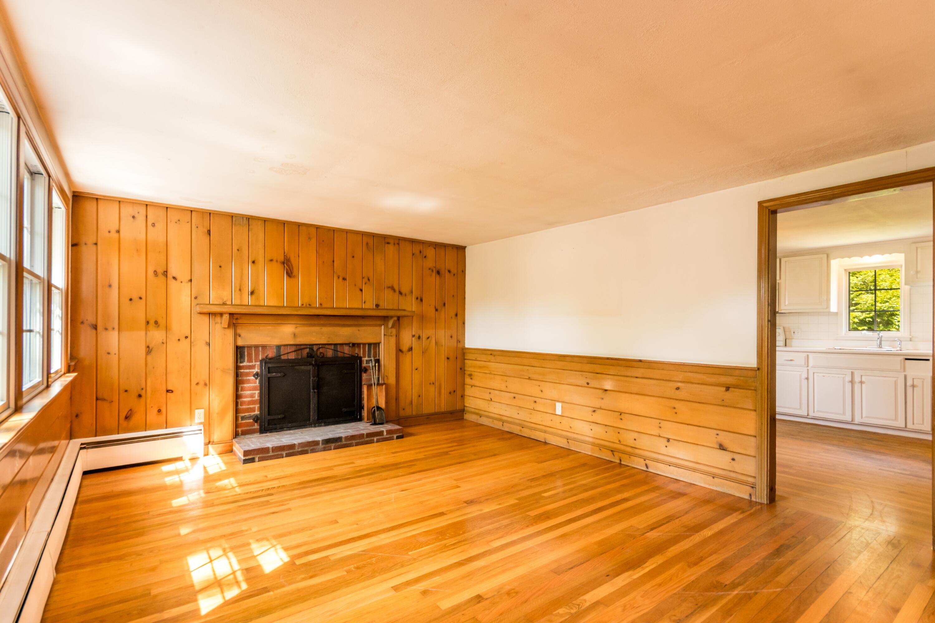 14 Ahab Road Yarmouth Port, MA 02675 - Photo 13 of 36 a view of an empty room with wooden floor and a fireplace