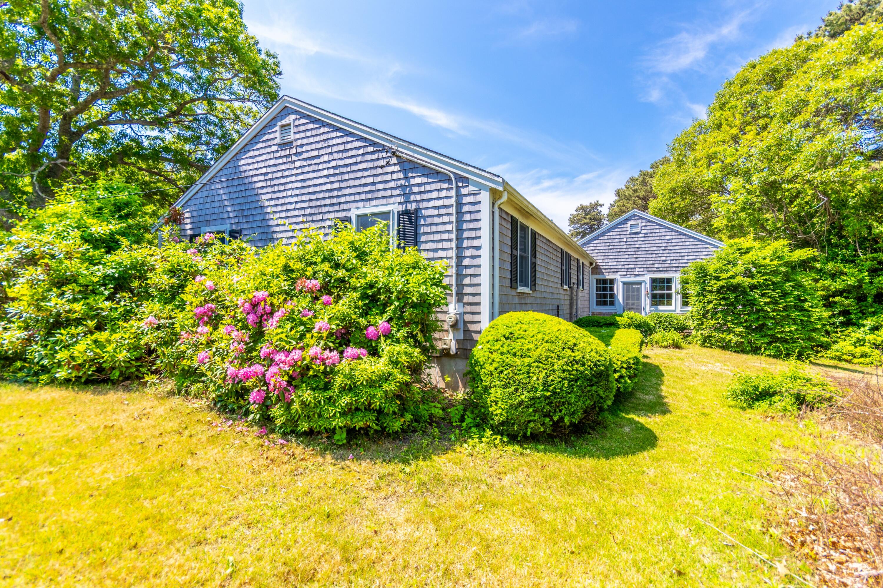 14 Ahab Road Yarmouth Port, MA 02675 - Photo 29 of 36 a front view of a house with a yard and fountain