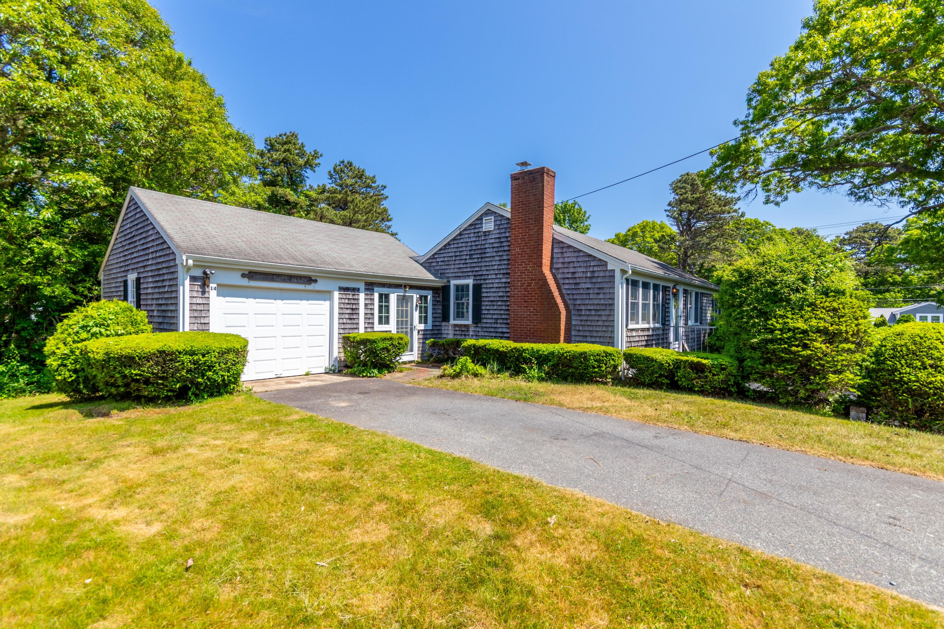 14 Ahab Road Yarmouth Port, MA 02675 - Photo 4 of 36 a front view of a house with a yard and potted plants