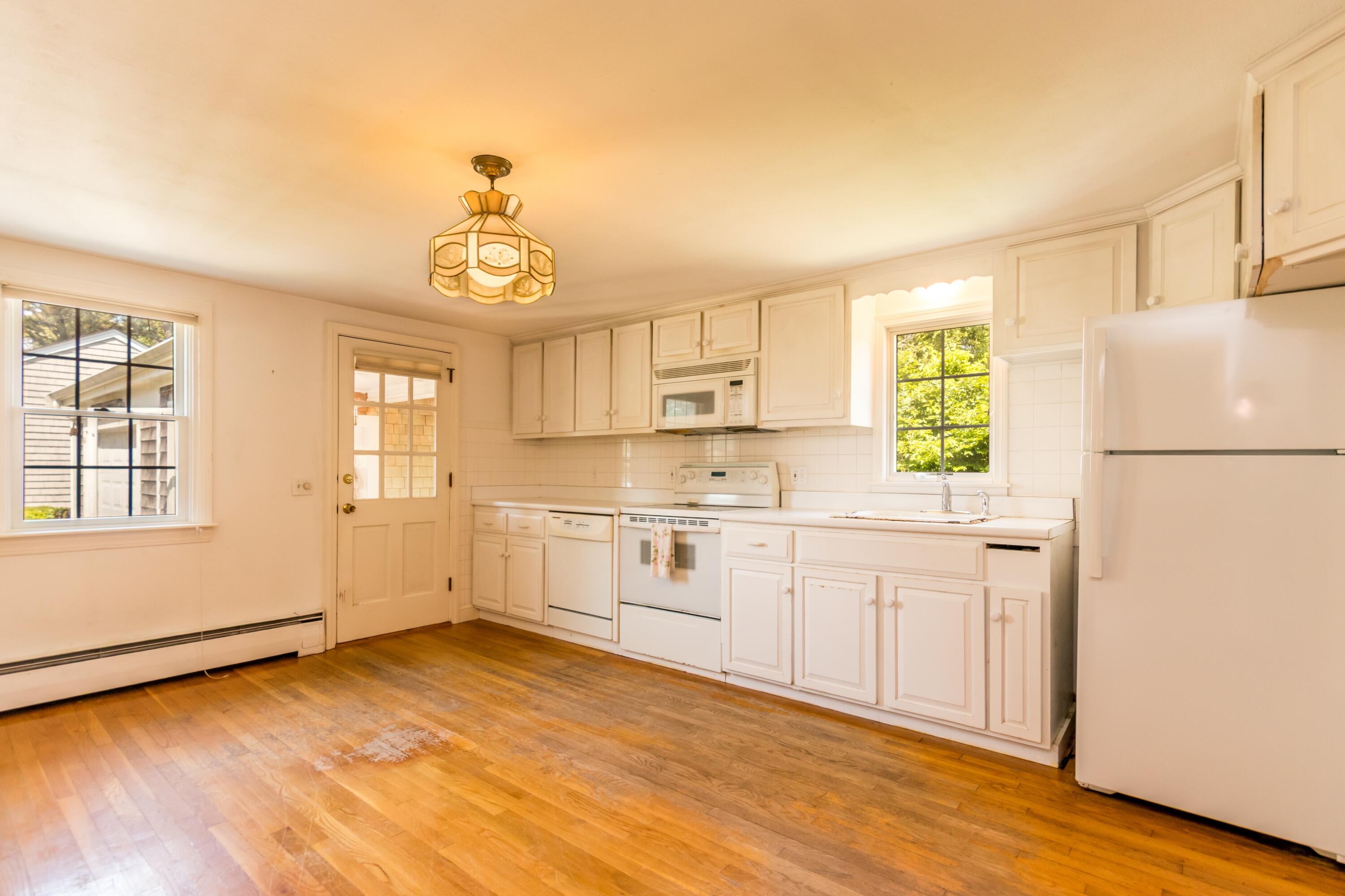 14 Ahab Road Yarmouth Port, MA 02675 - Photo 8 of 36 a kitchen with a refrigerator a stove cabinets and wooden floor