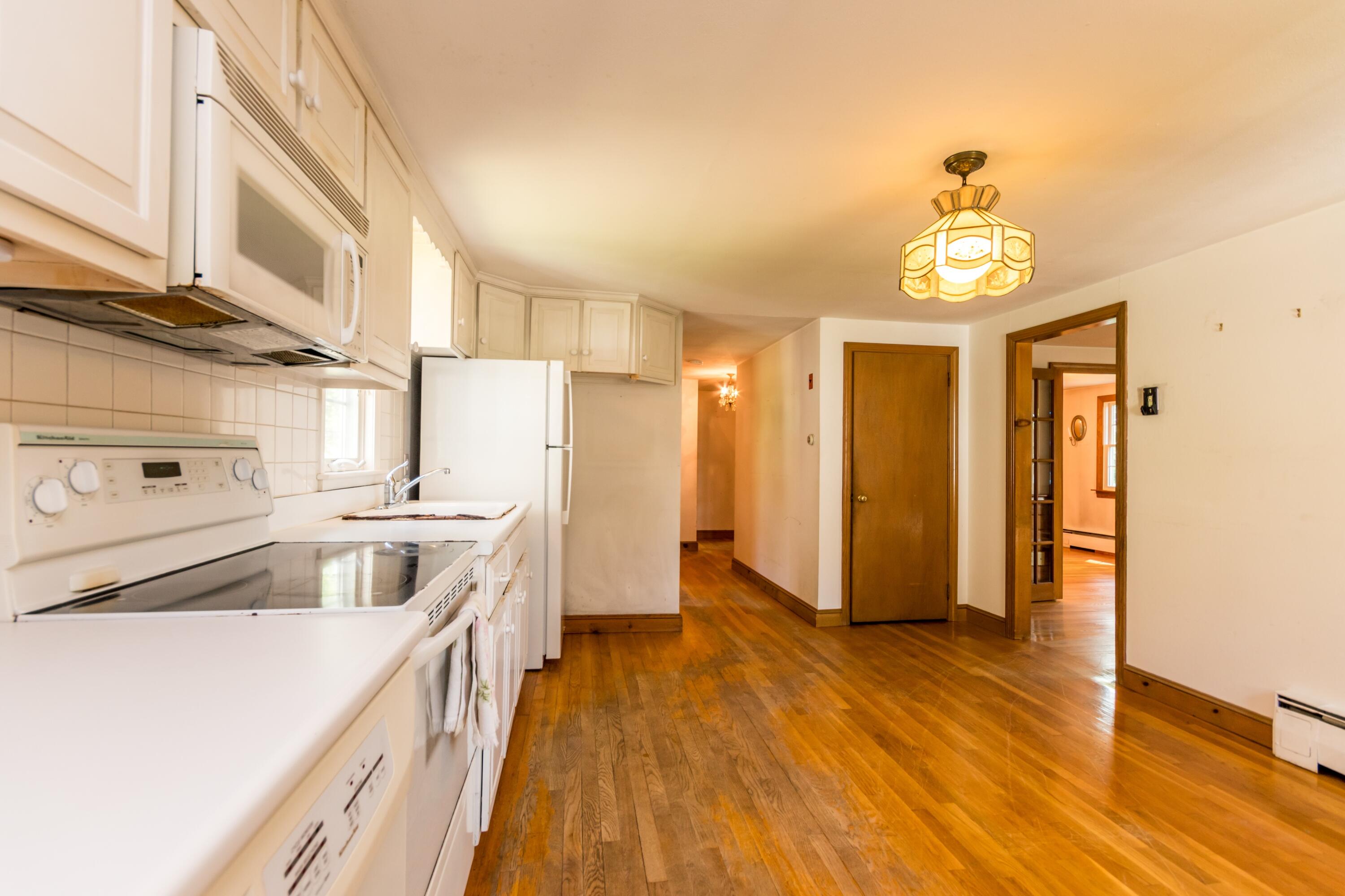 14 Ahab Road Yarmouth Port, MA 02675 - Photo 9 of 36 a kitchen with stainless steel appliances a stove a sink and a refrigerator