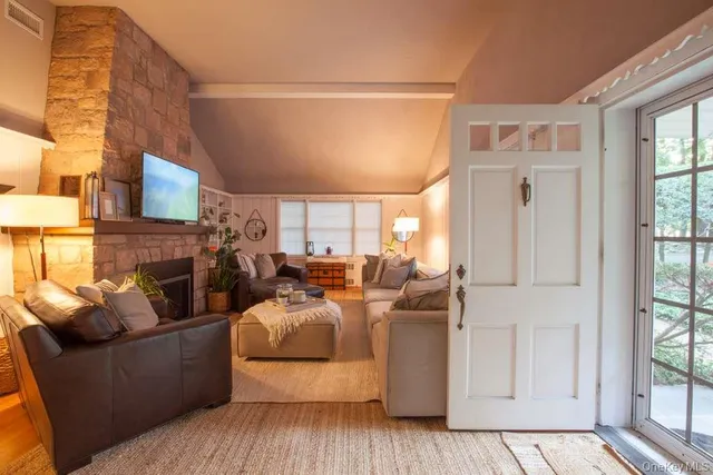a view of a hallway with a livingroom and furniture
