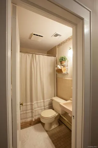 a bedroom with a bed and a television