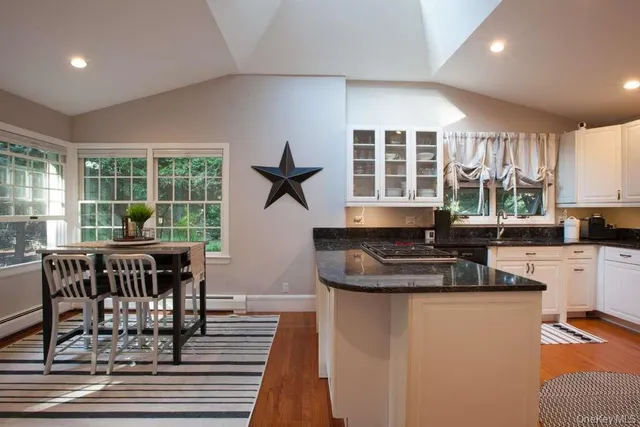 a kitchen with granite countertop lots of counter top space and wooden floor