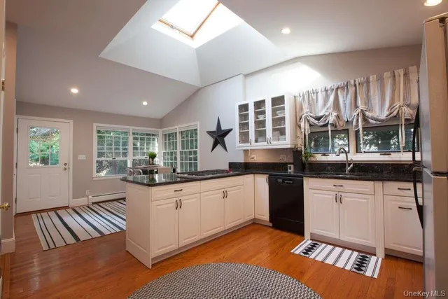 a dining room with furniture a chandelier and wooden floor