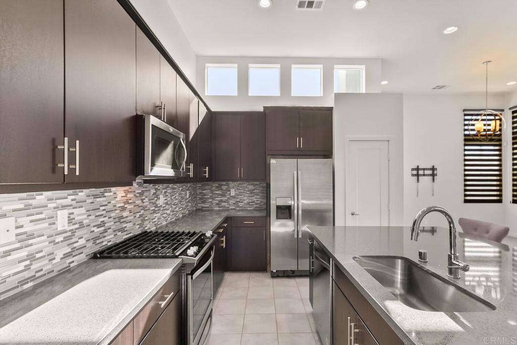 2012 Foxtrot Loop, Unit 3 Chula Vista, CA 91915 - Photo 5 of 34 a kitchen with granite countertop a sink stainless steel appliances and cabinets