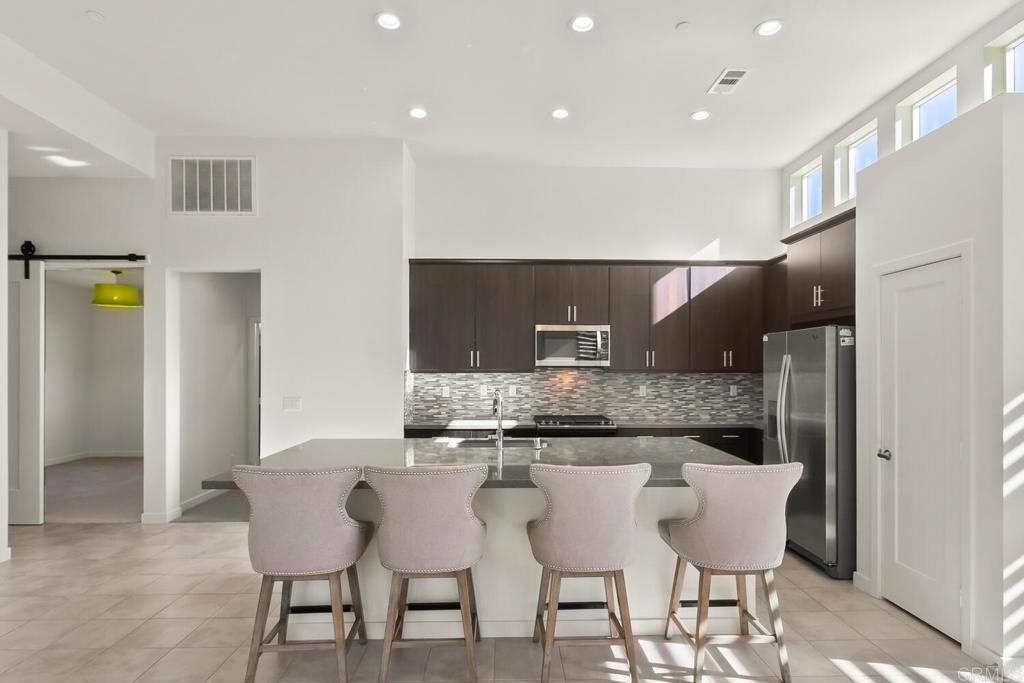 2012 Foxtrot Loop, Unit 3 Chula Vista, CA 91915 - Photo 6 of 34 a kitchen with kitchen island cabinets and refrigerator