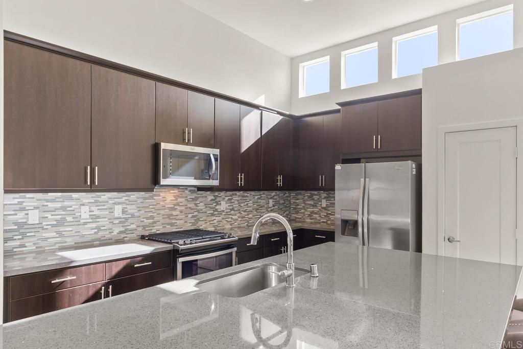 2012 Foxtrot Loop, Unit 3 Chula Vista, CA 91915 - Photo 7 of 34 a kitchen with stainless steel appliances granite countertop a refrigerator and a sink