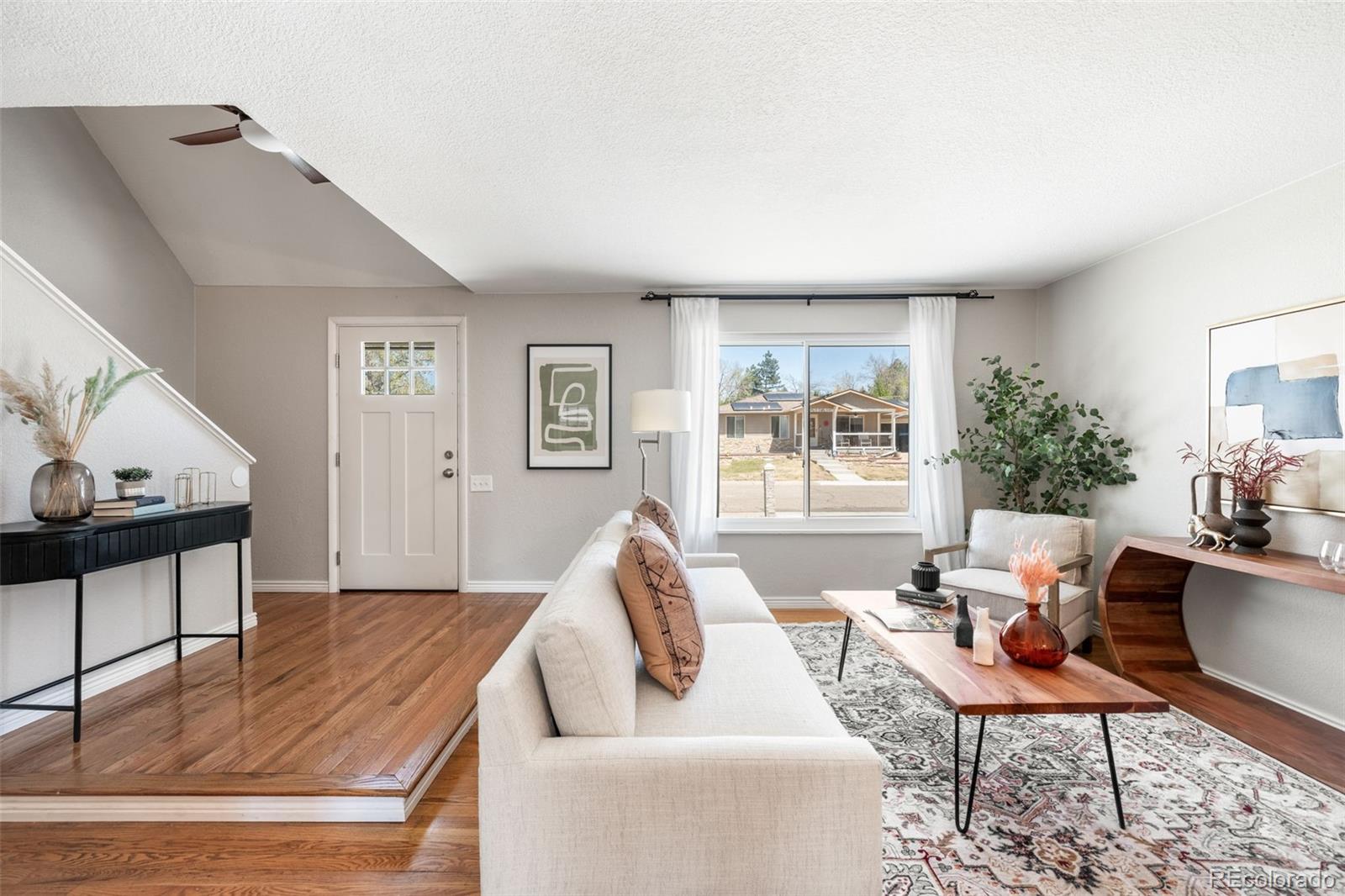 7186 West 79th Drive Arvada, CO 80003 - Photo 10 of 43 a living room with furniture and a window