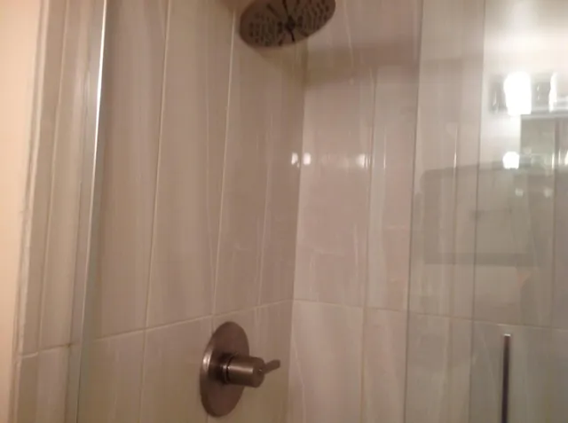 a view of staircase with railing and a window