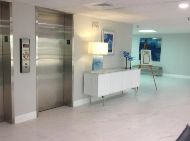 a view of a swimming pool with outdoor seating