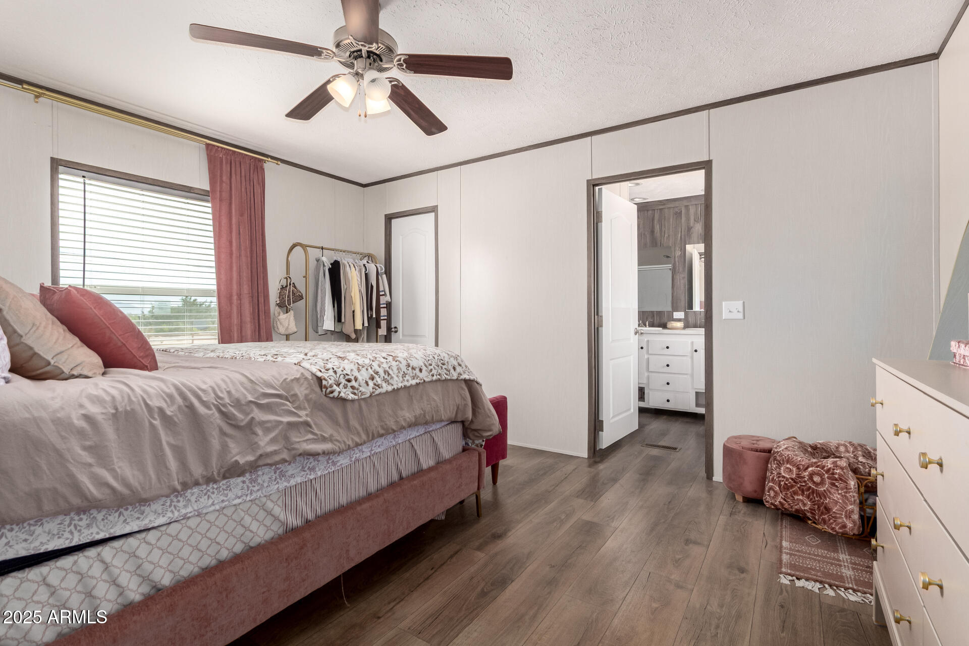 18709 West Riggs Road Buckeye, AZ 85326 - Photo 12 of 29 a bedroom with a bed and a chandelier