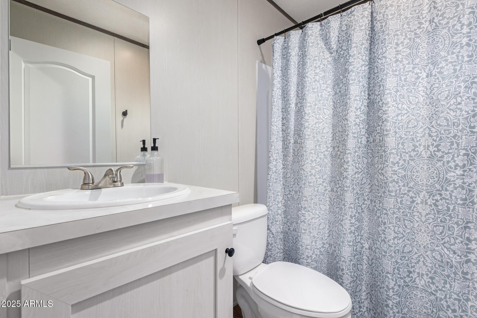 18709 West Riggs Road Buckeye, AZ 85326 - Photo 19 of 29 a bathroom with a granite countertop sink and a mirror