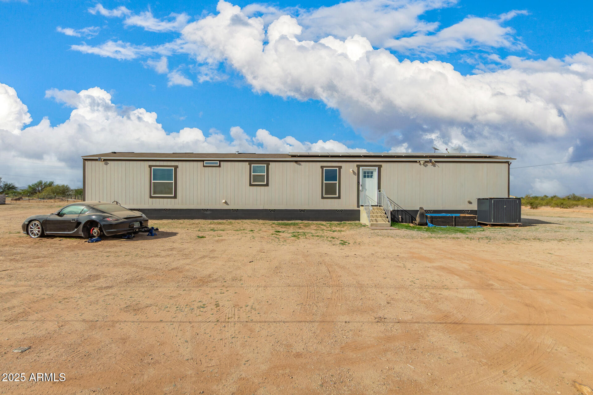 18709 West Riggs Road Buckeye, AZ 85326 - Photo 2 of 29 a view of a house with wooden fence