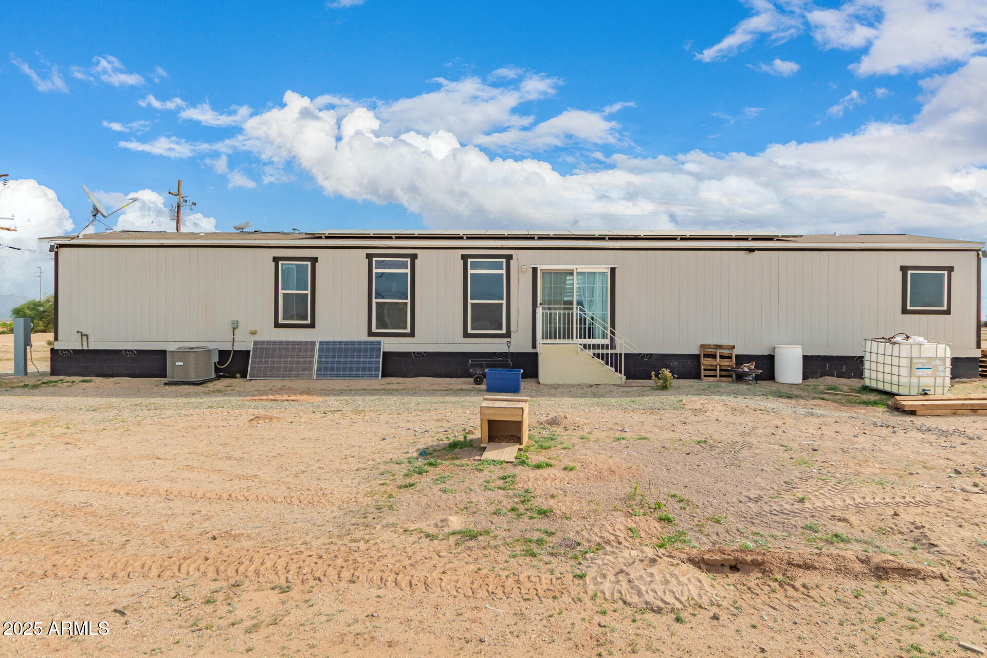 18709 West Riggs Road Buckeye, AZ 85326 - Photo 26 of 29 a backyard of a house with table and chairs