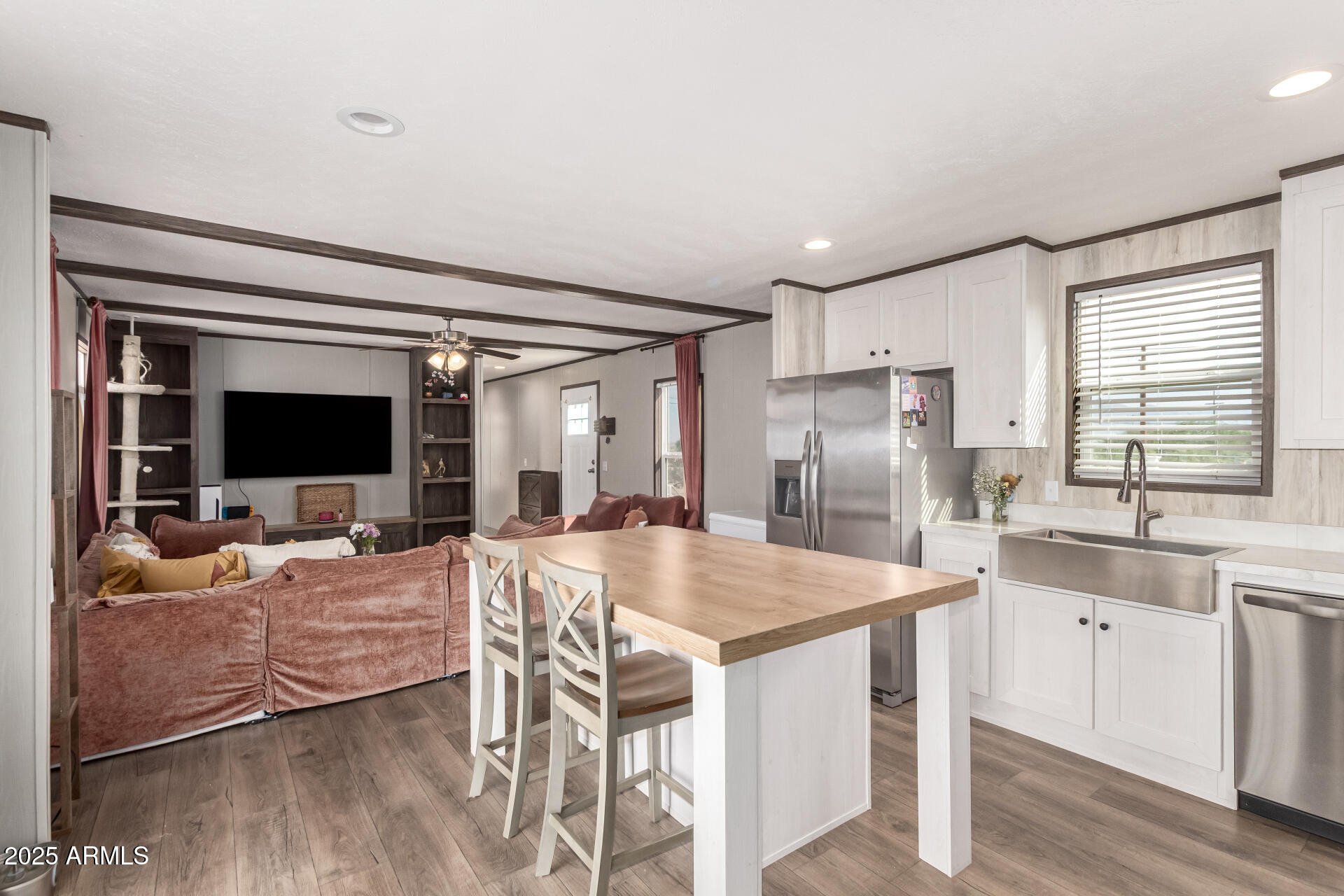 18709 West Riggs Road Buckeye, AZ 85326 - Photo 7 of 29 a kitchen with a table chairs refrigerator and cabinets