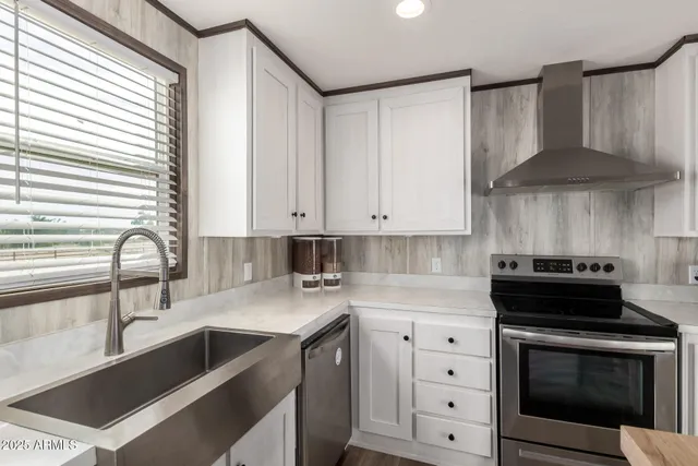 a kitchen with cabinets appliances and a sink
