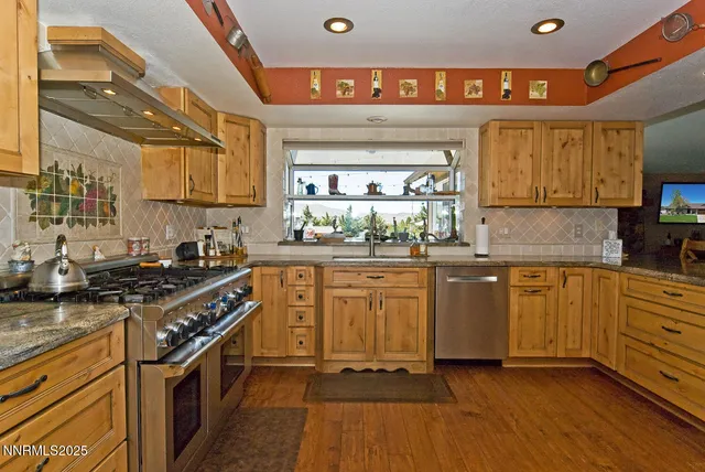 a kitchen with stainless steel appliances granite countertop a stove oven and a refrigerator