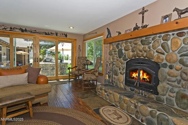 a living room with furniture and floor to ceiling windows