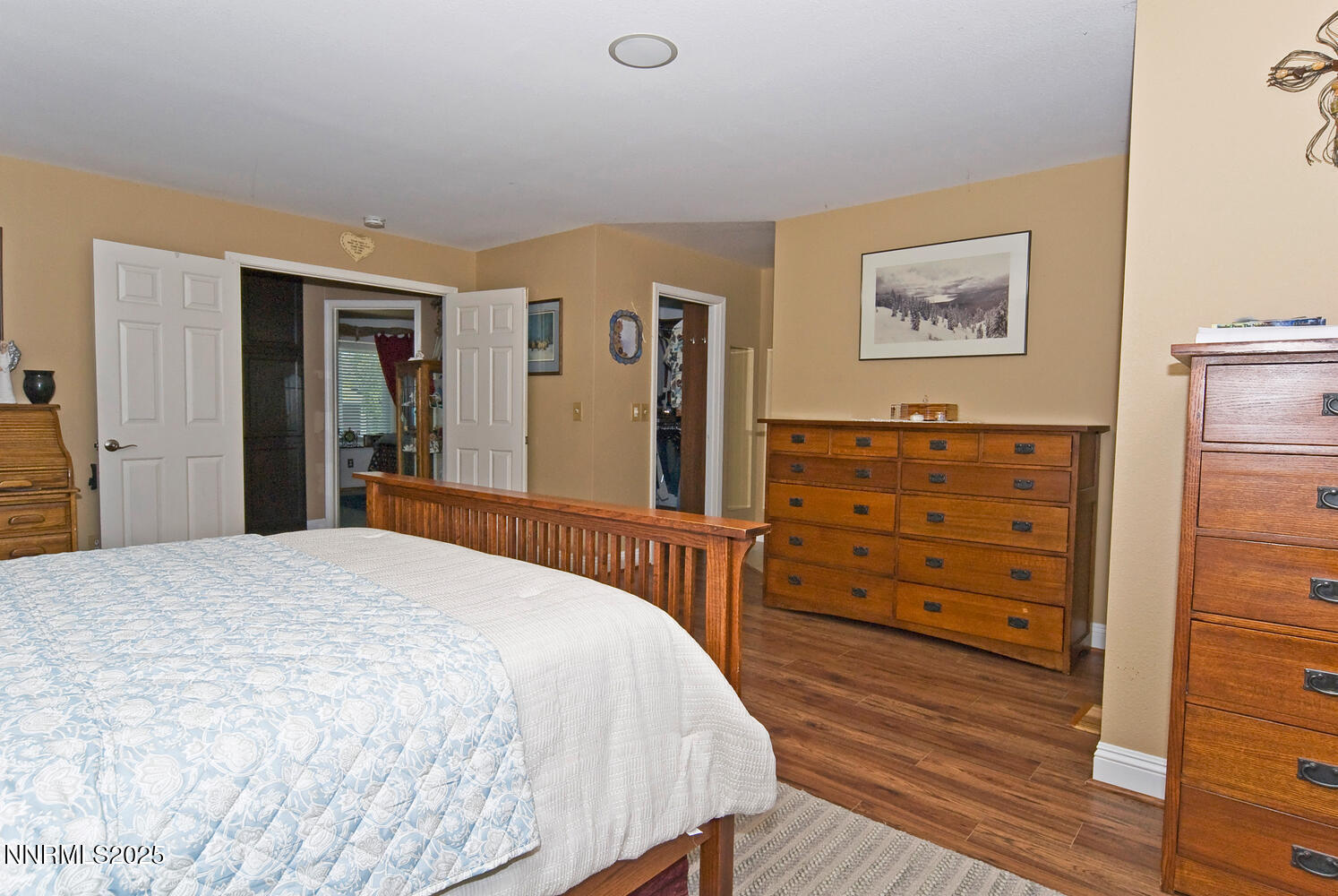 25 Martell Place Sparks, NV 89441 - Photo 39 of 68 a bedroom with a bed and wooden floor