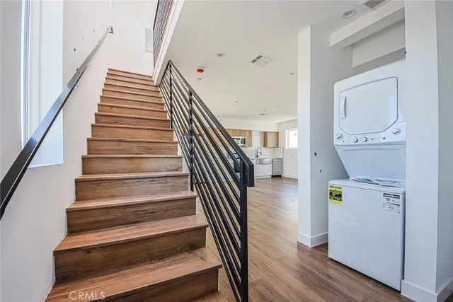 a view of entryway and hall with wooden floor