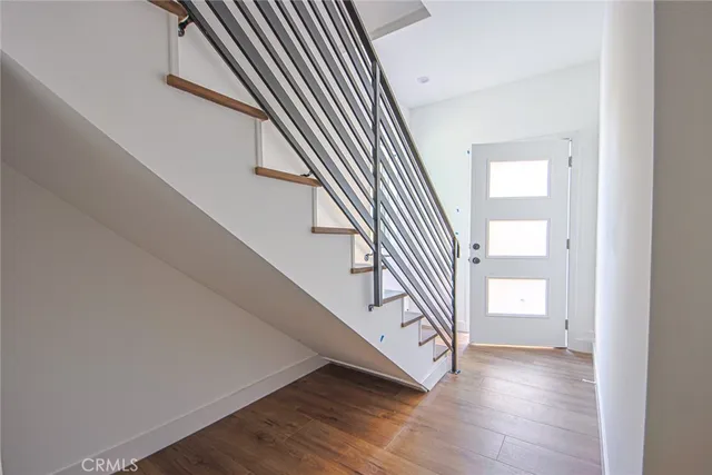 a view of staircase with white walls and a window
