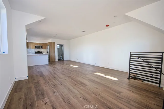 a view of a kitchen with a sink and dishwasher wooden floor