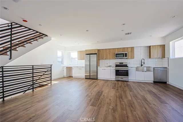 a kitchen with stainless steel appliances a stove top oven and cabinets