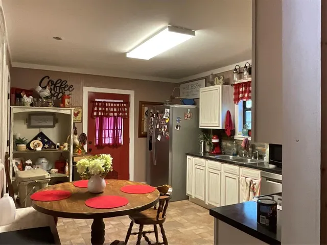 a kitchen that has a table and chairs in it