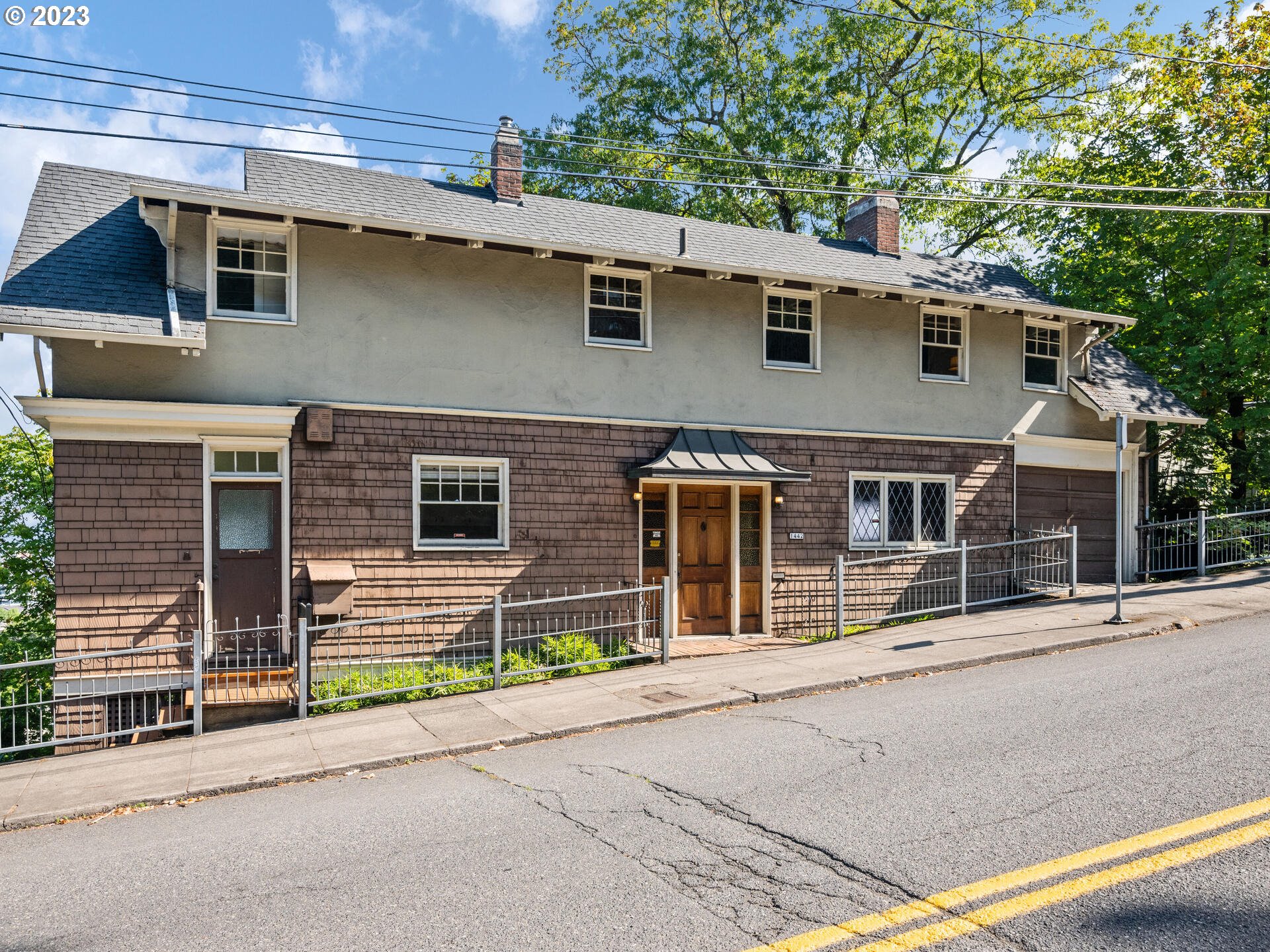 1442 Southwest Vista Avenue Portland, OR 97201 - Photo 1 of 46 a front view of a house with a garage