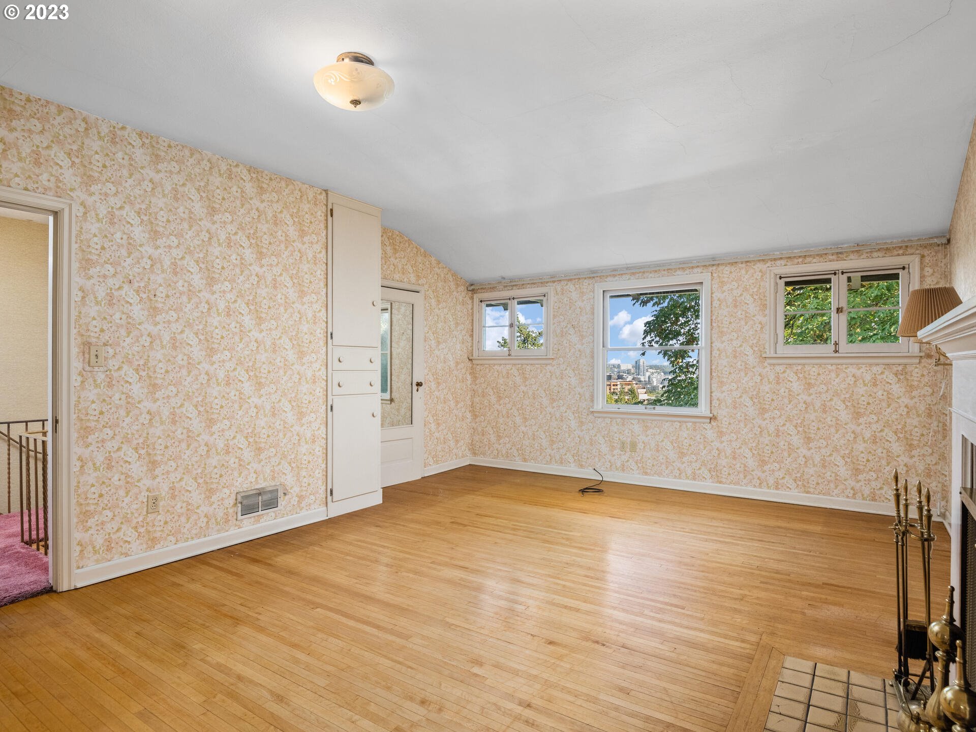 1442 Southwest Vista Avenue Portland, OR 97201 - Photo 20 of 46 a view of an empty room with window and wooden floor