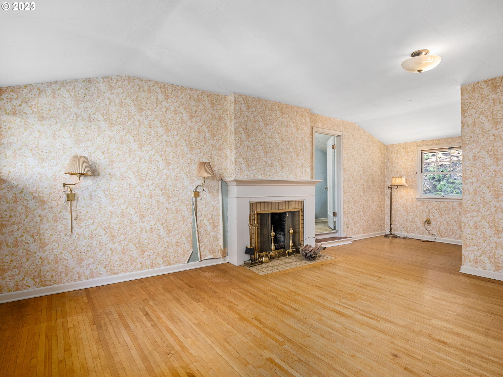 1442 Southwest Vista Avenue Portland, OR 97201 - Photo 24 of 46 a view of empty room with wooden floor and fireplace