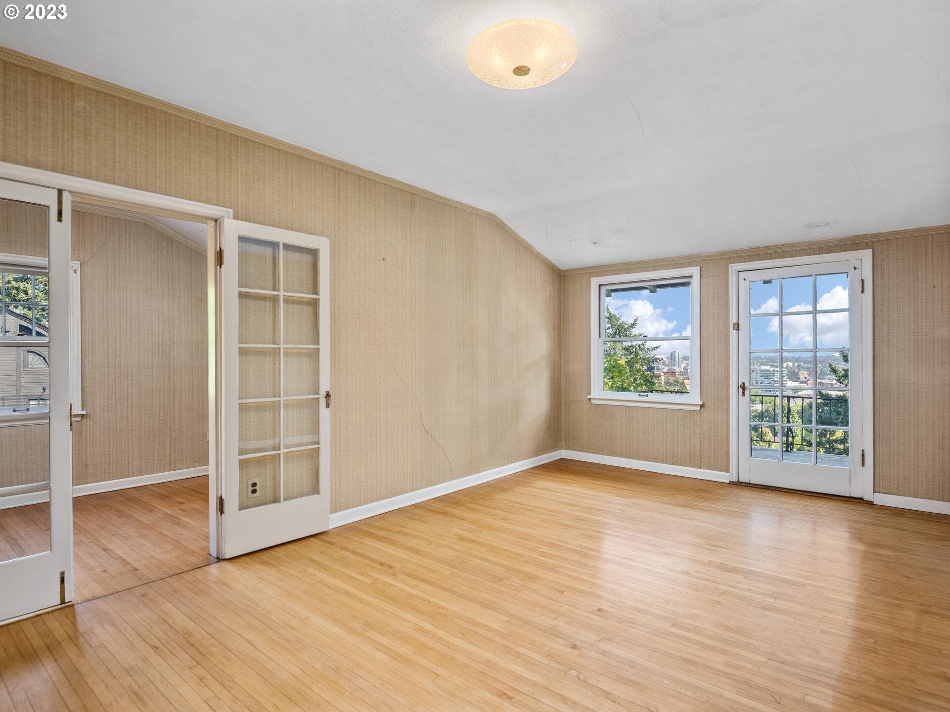 1442 Southwest Vista Avenue Portland, OR 97201 - Photo 28 of 46 an empty room with wooden floor and windows