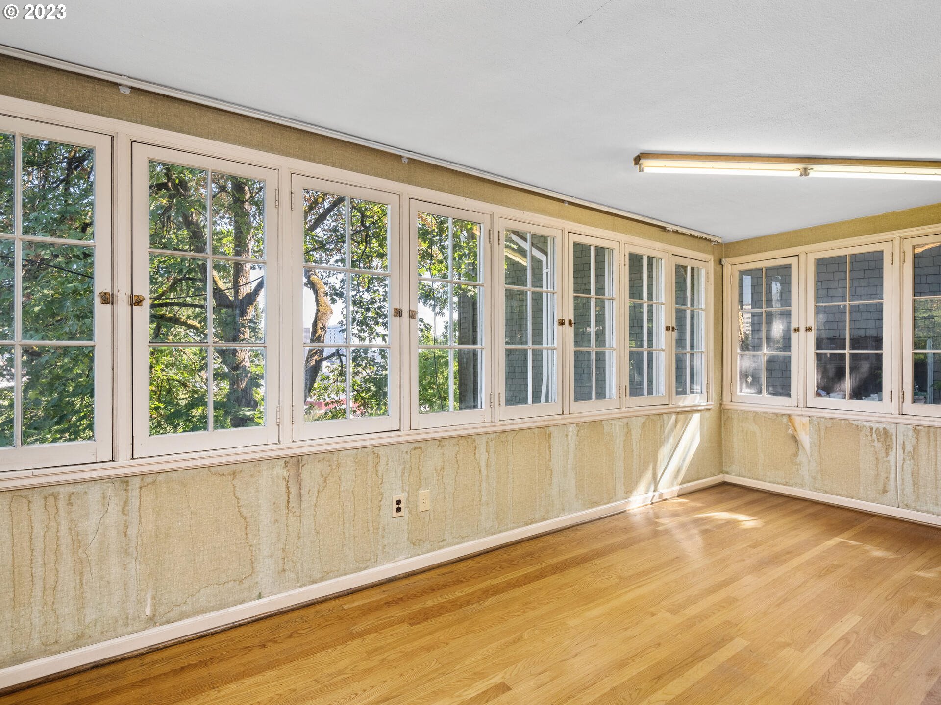 1442 Southwest Vista Avenue Portland, OR 97201 - Photo 7 of 46 a view of an empty room with wooden floor and a window