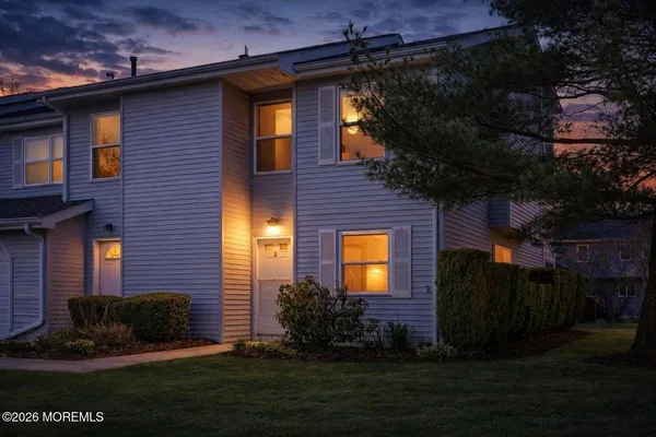 a view of a brick house with a yard next to a yard