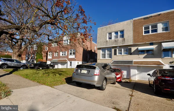 a car parked in front of a brick house