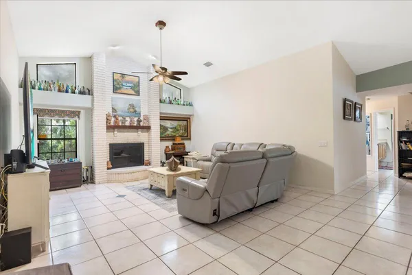 a living room with furniture and a ceiling fan