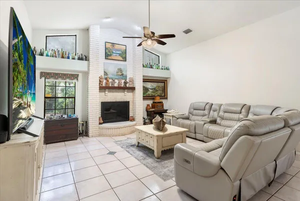 a kitchen with stainless steel appliances granite countertop a refrigerator a stove and a sink with wooden cabinets