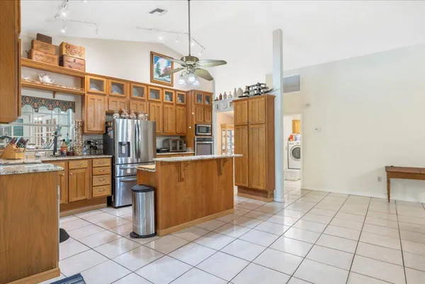 a bedroom with a bed and a table with a bookshelf