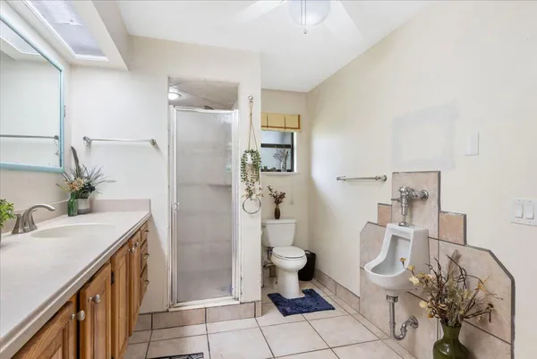 an empty room with windows and chandelier fan