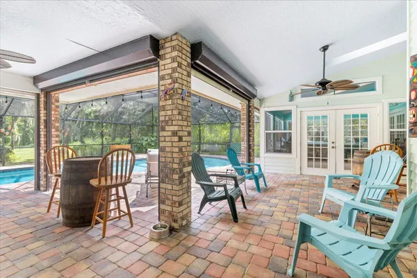 a backyard of a house with table and chairs