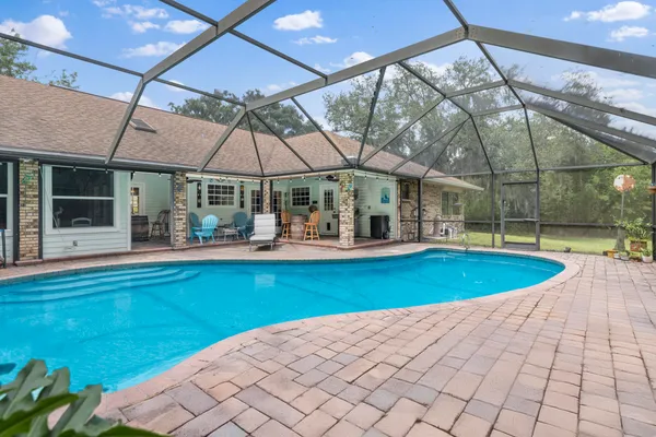 an aerial view of a house with a yard and lake view