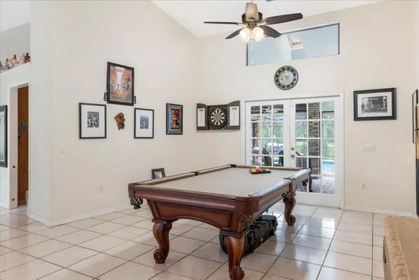 a room with gym equipment and view of kitchen