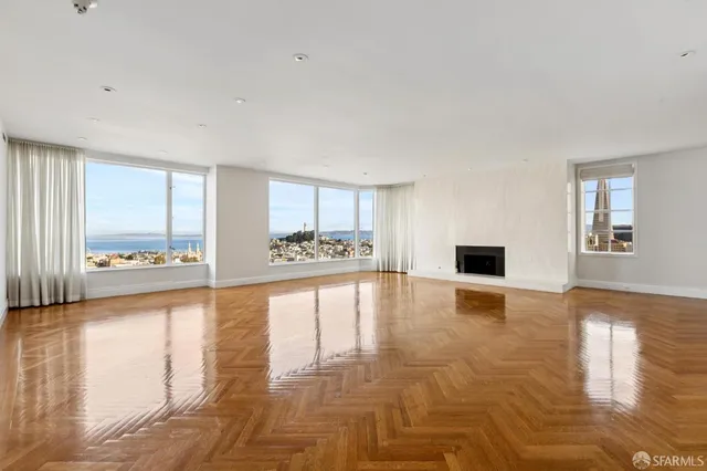 a view of a living room and floor to ceiling window or wooden floor