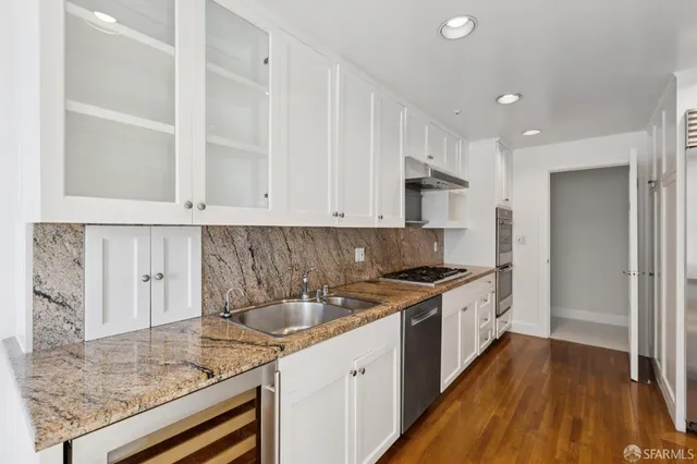 a kitchen with a sink stove and cabinets